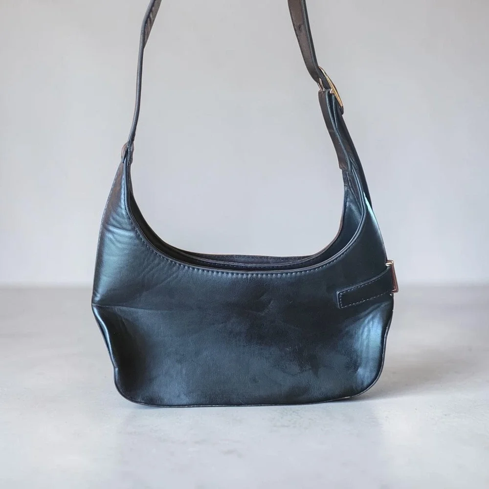 Minimalist black hobo shoulder bag gold hardware under arm‎